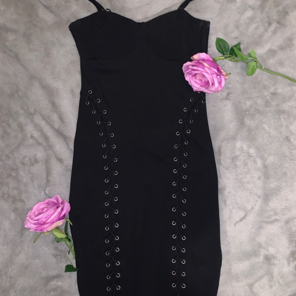 Black Bodycon dress w/lace up detail.